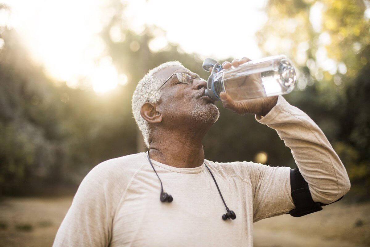 Man drinking water - illustrating swallowing health improvement